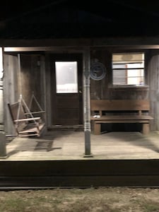 Cabin with 40 ft porch overlooking a pond. 