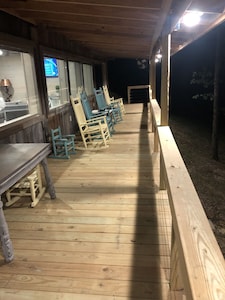 Cabin with 40 ft porch overlooking a pond. 