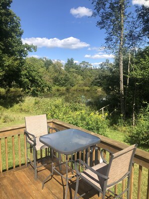 Intimate bar height table and chairs overlook the pond. 
