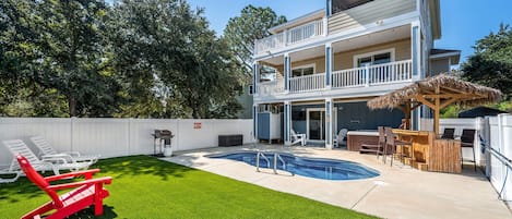 Relaxation at its best: A pool, beach chairs, and a glimpse of the backyard.