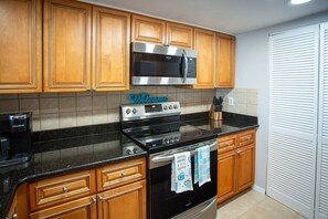 Fully Equipped Kitchen Ready for Any Meal Preparation with Granite Counters and Updated Appliances