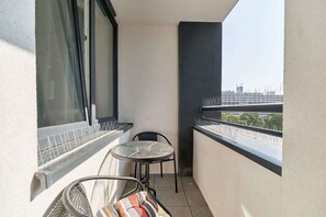 Spacious balcony with outdoor furniture. 