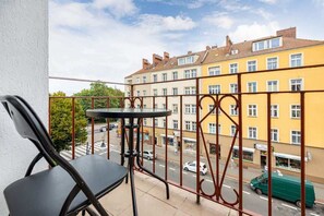 Spacious balcony with outdoor furniture. 