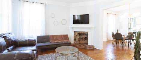 The living Room has a sleeper sofa and smart TV.