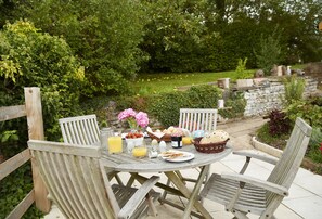 Outdoor dining area with wooden garden furniture