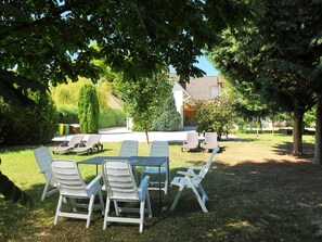 Plant, Table, Furniture, Chair, Tree, Outdoor Table, Shade, Outdoor Furniture, Natural Landscape, Grass