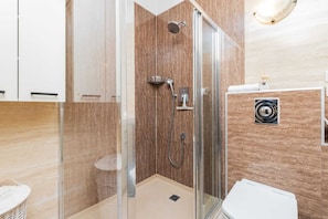 Elegant bathroom with a shower, sink, and modern finishes.
