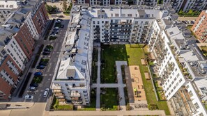 An aerial view of the building complex, showing the layout of the surrounding structures and green spaces.
