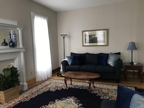 Living room with sofa, loveseat and two comfortable chairs.