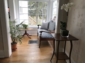 The quiet sunroom overlooks the back yard.