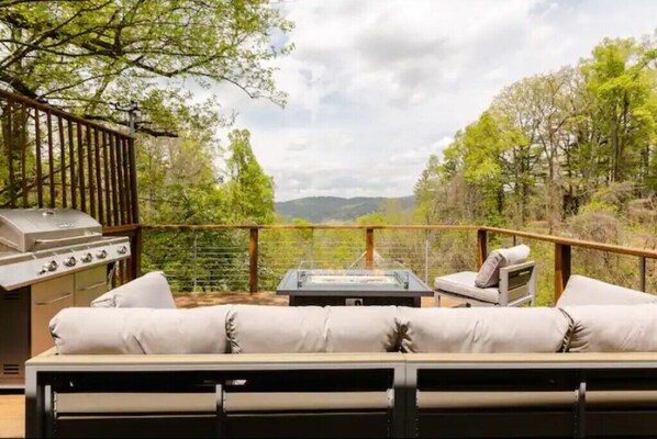 Deck with a fire table, comfortable seating, and a great view!