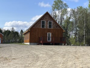 Entry with plenty of parking. Granite fire pit is to right against tree line. 