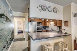 Eat in bar between kitchen and dining area.