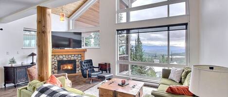 Living space with soaring two storey windows with panoramic views.