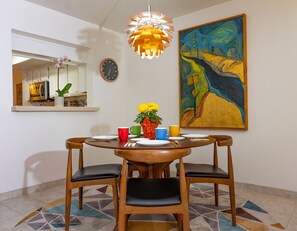 Mid-century dining table and chairs with artichoke lamp.