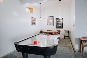 Air hockey table and game table in the garage area