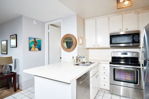 The kitchen features stainless appliances.