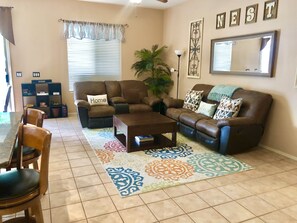 Open floor plan. Living room has two leather reclining sofas.