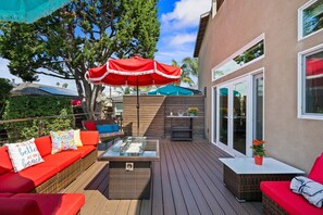 Private outdoor lounge seating with fire table and pyramid heater.  The brown dividers divide the Hideaway from the main house. 