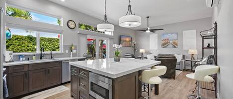 Modern kitchen with open concept, living room, overlooking the exterior lounge deck.  