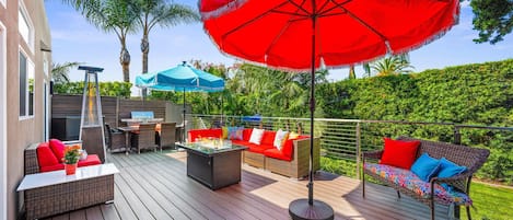 Outdoor Lounge Deck, connecting both homes; includes lounge seating, fire table, patio heater, BBQ, umbrellas