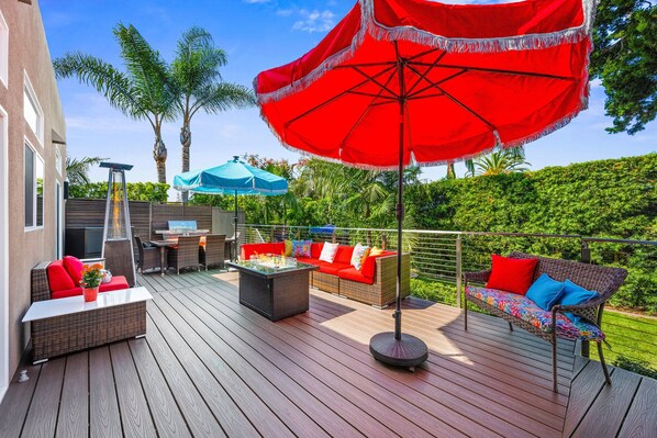 Outdoor Lounge Deck, connecting both homes; includes lounge seating, fire table, patio heater, BBQ, umbrellas