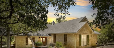 The landscaping and construction of the Guadalupe River Retreat make it look right at home in its riverside setting.