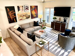 Large windows surround the kitchen/living area, allowing trail views.