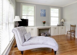 Master bedroom with chaise lounge and television. (Wardrobe not shown)