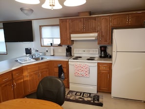 Kitchen  - Electric Stove and Oven, Microwave and Refrigerator (No Ice Maker)