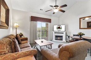 Living Room with Balcony Access, Fireplace and Cable TV.