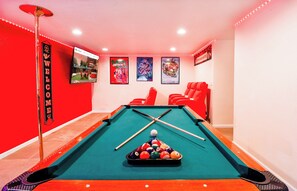 Unwind in style: Private theater room with plush seating and a pool table for the ultimate entertainment experience.