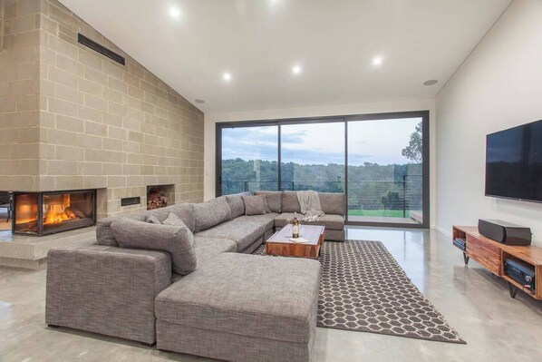 Relax in the inviting lounge with plush seating, a feature stone fireplace, and panoramic views.