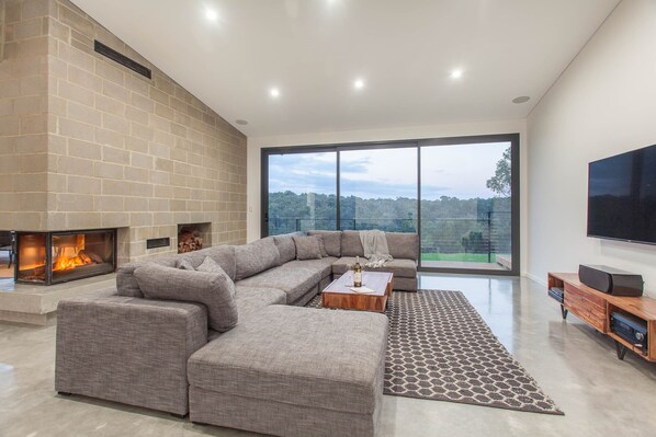 Relax in the inviting lounge with plush seating, a feature stone fireplace, and panoramic views.