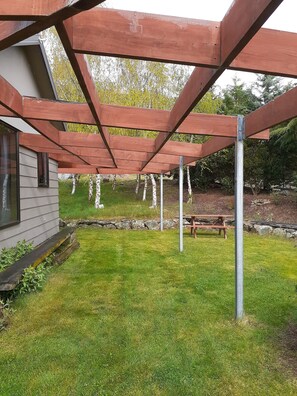 West side of house with pergola and lawn