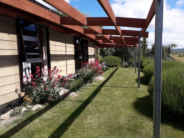 Front of cottage with pergola facing North with views of Lake Benmore