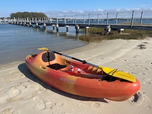 One of 4 kayaks on the private sandy beach next to boat dock.