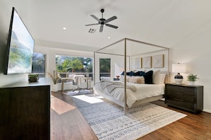 Master Bedroom: vaulted ceilings, king canopy bed, ceiling fan, backyard access