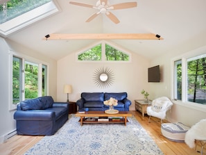 The big, airy living room has a couch that pulls out to a queen bed. 