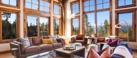 Main floor living room with mountain views and wood burning fireplace