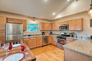 LARGE kitchen, granite, stainless steel, overlooks the lake and the pool.