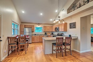 Breakfast bar and dining area with extension table. Seats are all stool-height. 