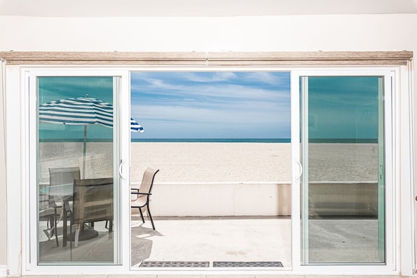 Sliding doors open from the living area to the front patio and beachfront. Vacation is served!