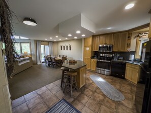 Open to kitchen with island seating, includes all the amenities!