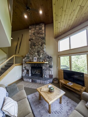 Open living space with beautiful stone fireplace.