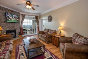 Living Room with Stone Gas Log Fireplace and Comfy Leather Furniture