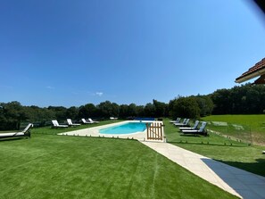 Private pool with many sun loungers