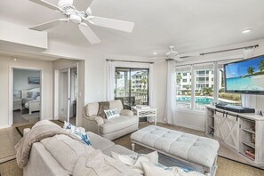 Living room with pool view and flat-screen television, Tidewater 101I, Isle of Palms, SC | IOP Escapes