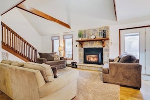 Living room with gas fireplace with lake view