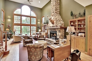 Great Room with comfortable seating and a wood-burning fireplace.